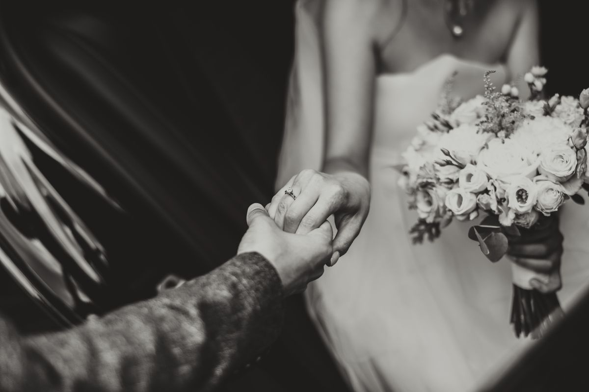 Bride and groom holding hands during the ceremony
